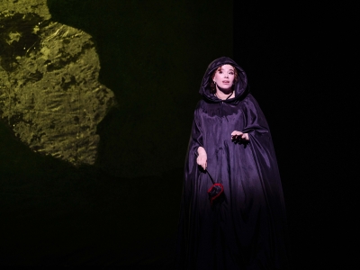 WNO The Marriage of Figaro Christina Gansch Susanna photo credit Dafydd Owen 07133 Susanna stands in the darkness of the night, dressed in this long hooded black cloak.